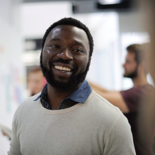 Smiling Black man working in Employee Assistance Program office