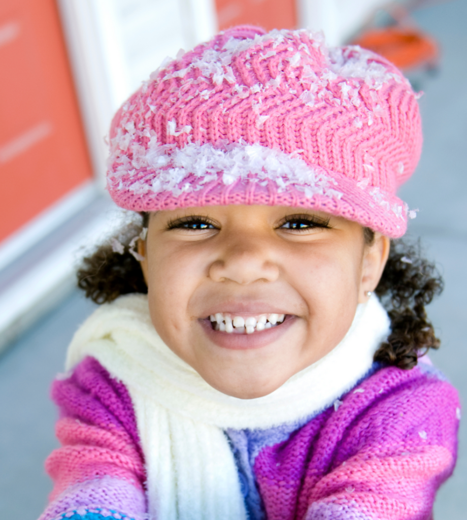 Smiling girl in winter hat and scarf