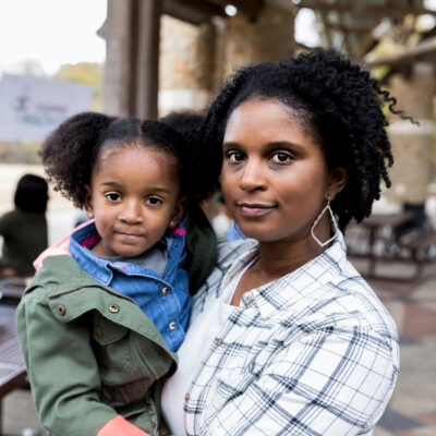 Black mom and daughter in outdoor park setting